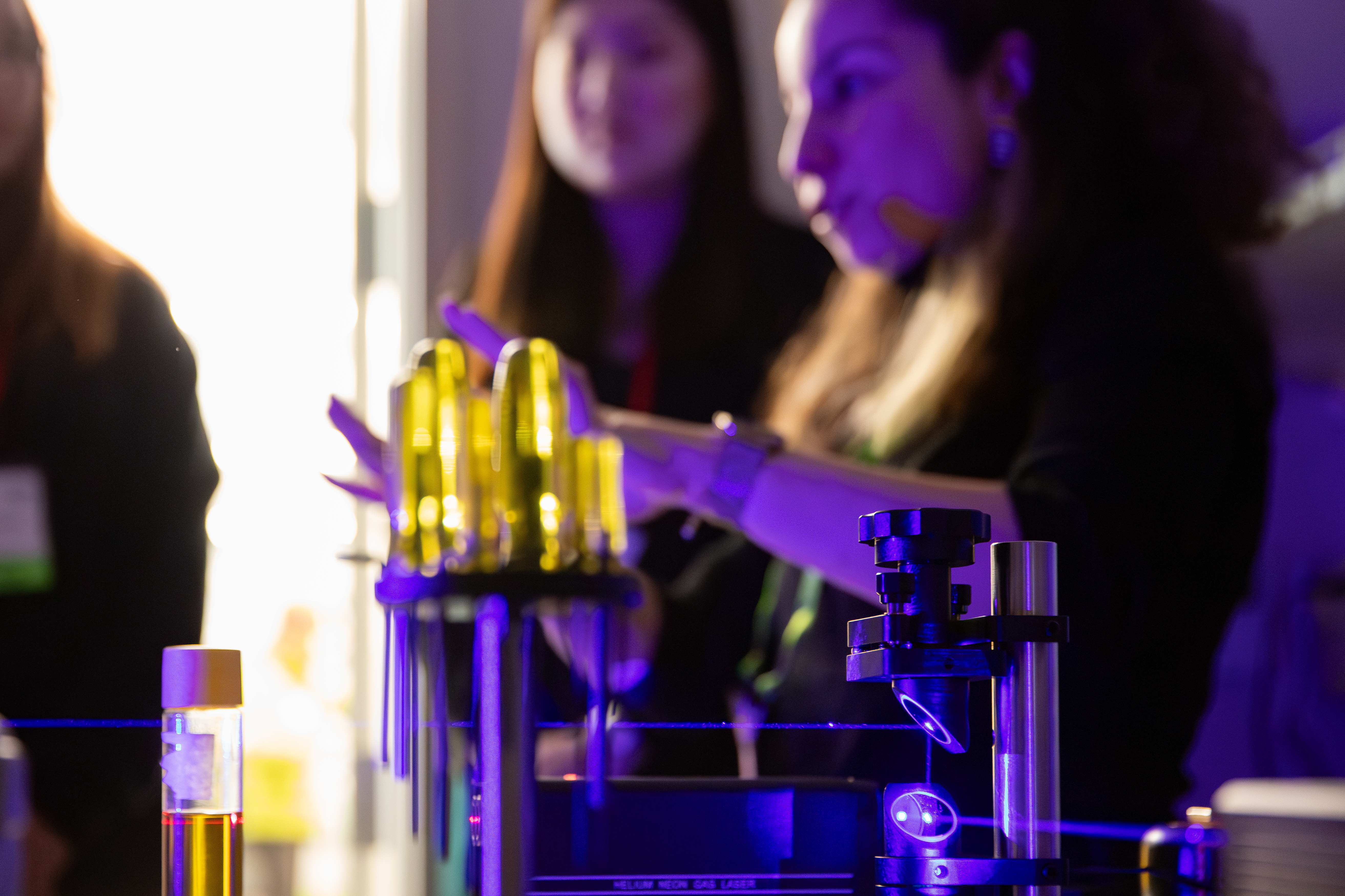 Students observe a laser optics demonstration during the APS Conference for Undergraduate Women and Gender Minorities in Physics at Cal Poly.