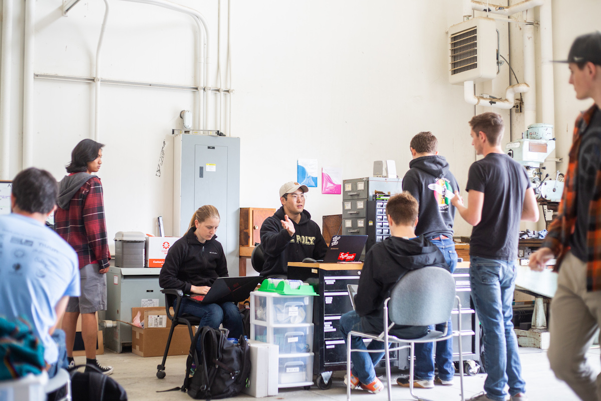 Students gathered around, discussing plans and solutions.