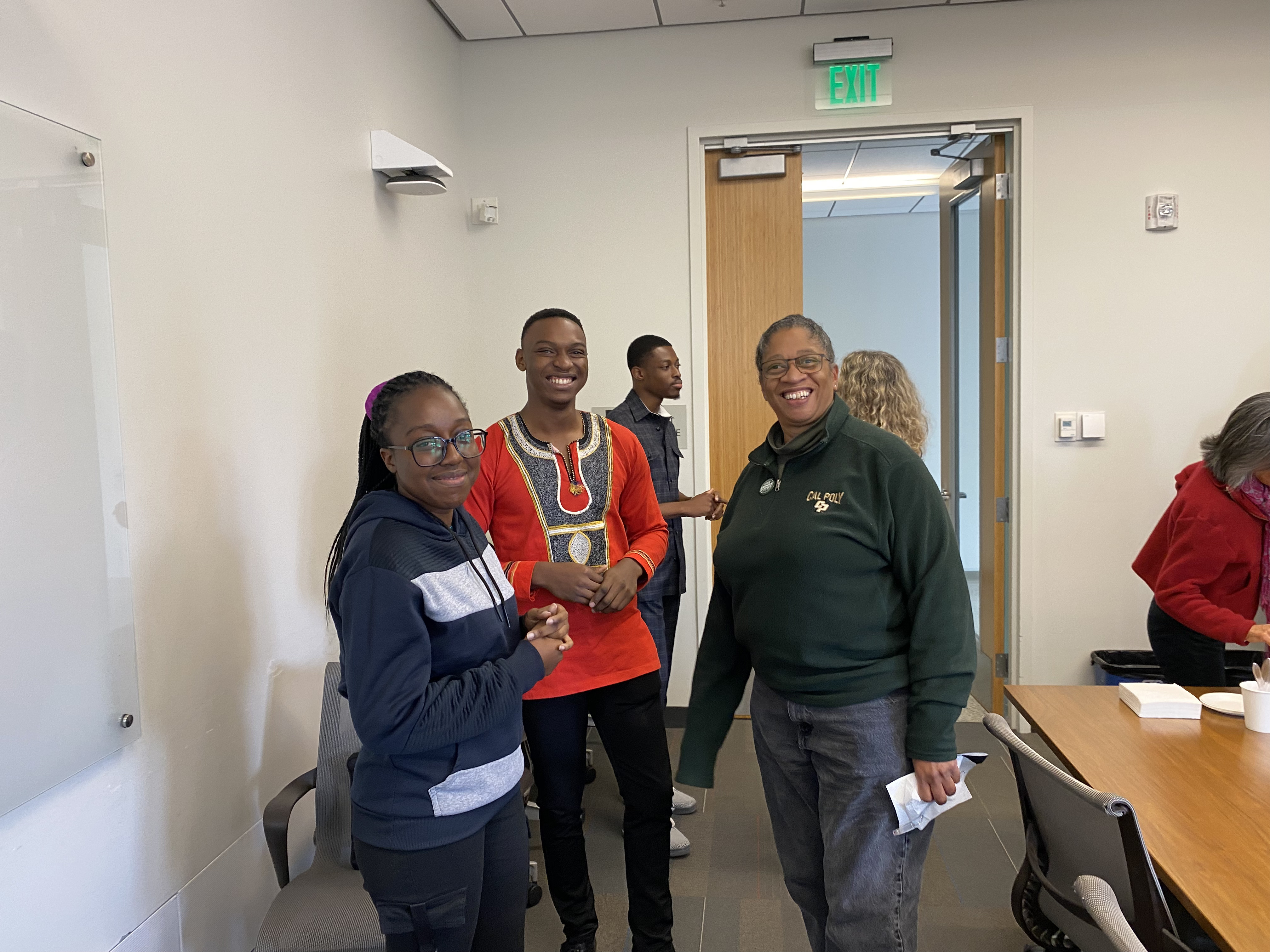 Ashesi University students Ropa Nhanga (front left) and Allen Lamtey Kpentey (from middle) attend a lunch alongside CSM Associate Dean Camille O’Bryant (front right). Samuel Asiedu-Awuah, the third of the Ashesi exchange students at Cal Poly this year, is in the background. 