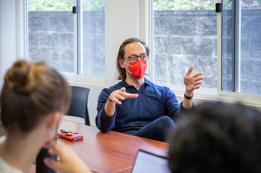 Statistics Assistant Professor Trevor Ruiz explains a concept to student researchers during a research team meeting.