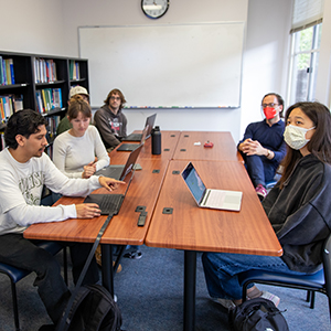 Statistics research students meet with Assistant Professor Trevor Ruiz during a team research meeting.