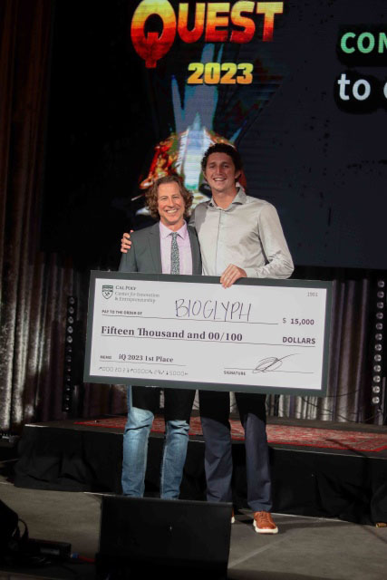 McClain Kressman and Nico Galin posing with a blow-up of a $15,000 check they won in the Innovation Quest competition.  