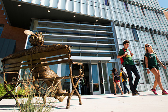 Stock image. Iconic statue foreground. Student exiting William J. Baker Center for Science and Mathematics. 