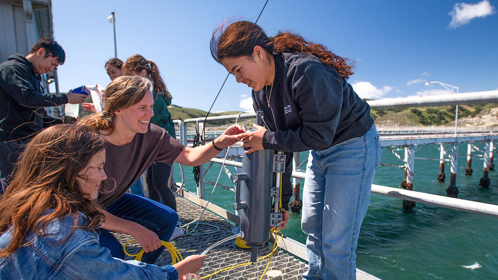 Professor and students doing research at the Cal Poly Pier.