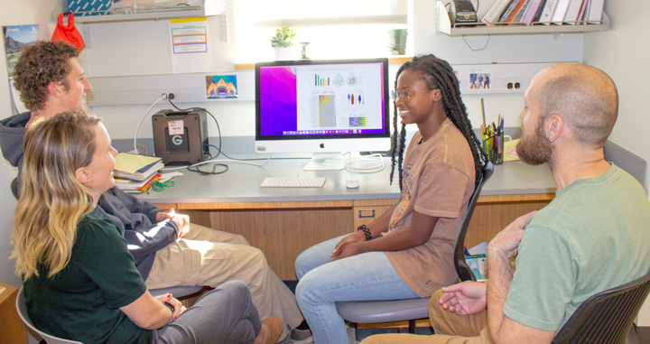 Cal Poly research group reviewing data on a computer in a lab.