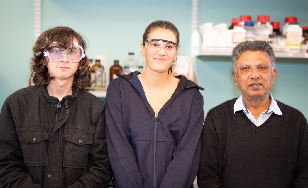Students Danega, Everitt and Ray Fernando standing in a lab.