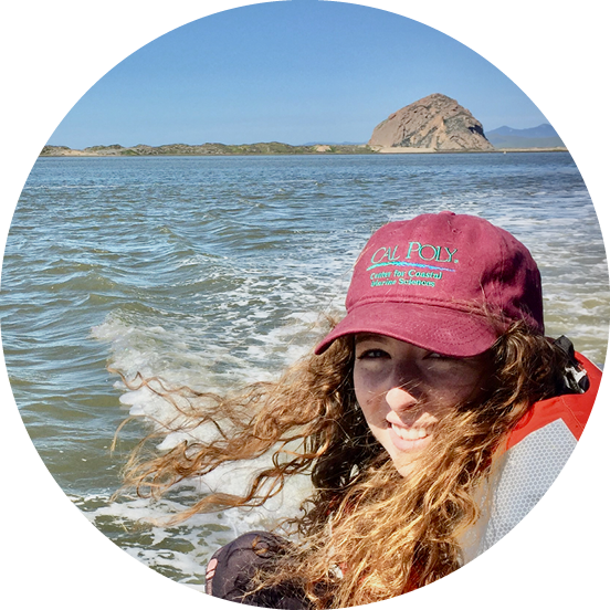 Hayley Farr Cal Poly alum wearing a red Cal Poly Center for Coastal Marine Sciences cap and life vest on a boat, with Morro Rock visible across the water in the background.