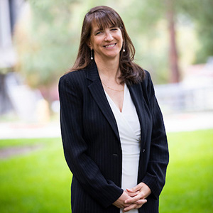 Portrait of Professor Beth Chance smiling outdoors.