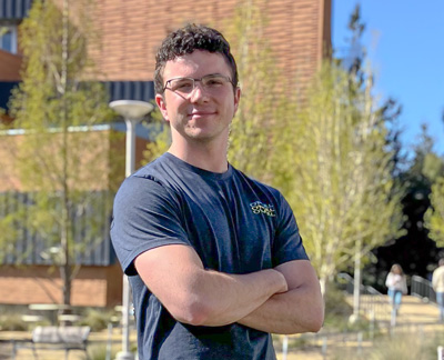 Jeff Wilson standing on the lawn in front of the Baker Center on a sunny day.