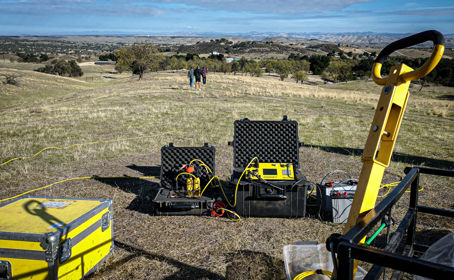 Cal Poly geophysics professor and student researchers set up electrical resistivity equipment in a rural field to survey underground rock layers while searching for deep groundwater on California’s Central Coast.