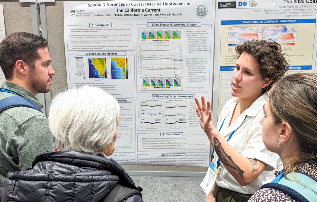 Isabelle Cobb Researcher presenting a poster on coastal marine heatwaves to attendees at a conference.