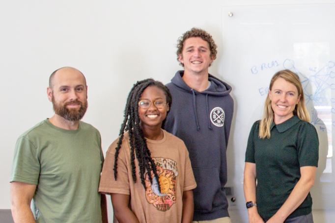 Cal Poly research group standing in front of a white board.