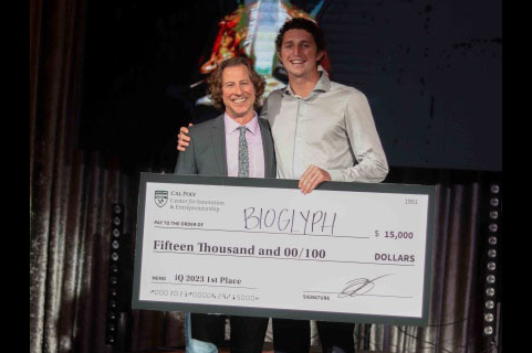 McClain Kressman and Nico Galin posing with a blow-up of a $15,000 check they won in the Innovation Quest competition.  