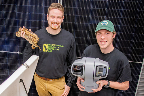 Student pose for photo with Rattlesnake cam