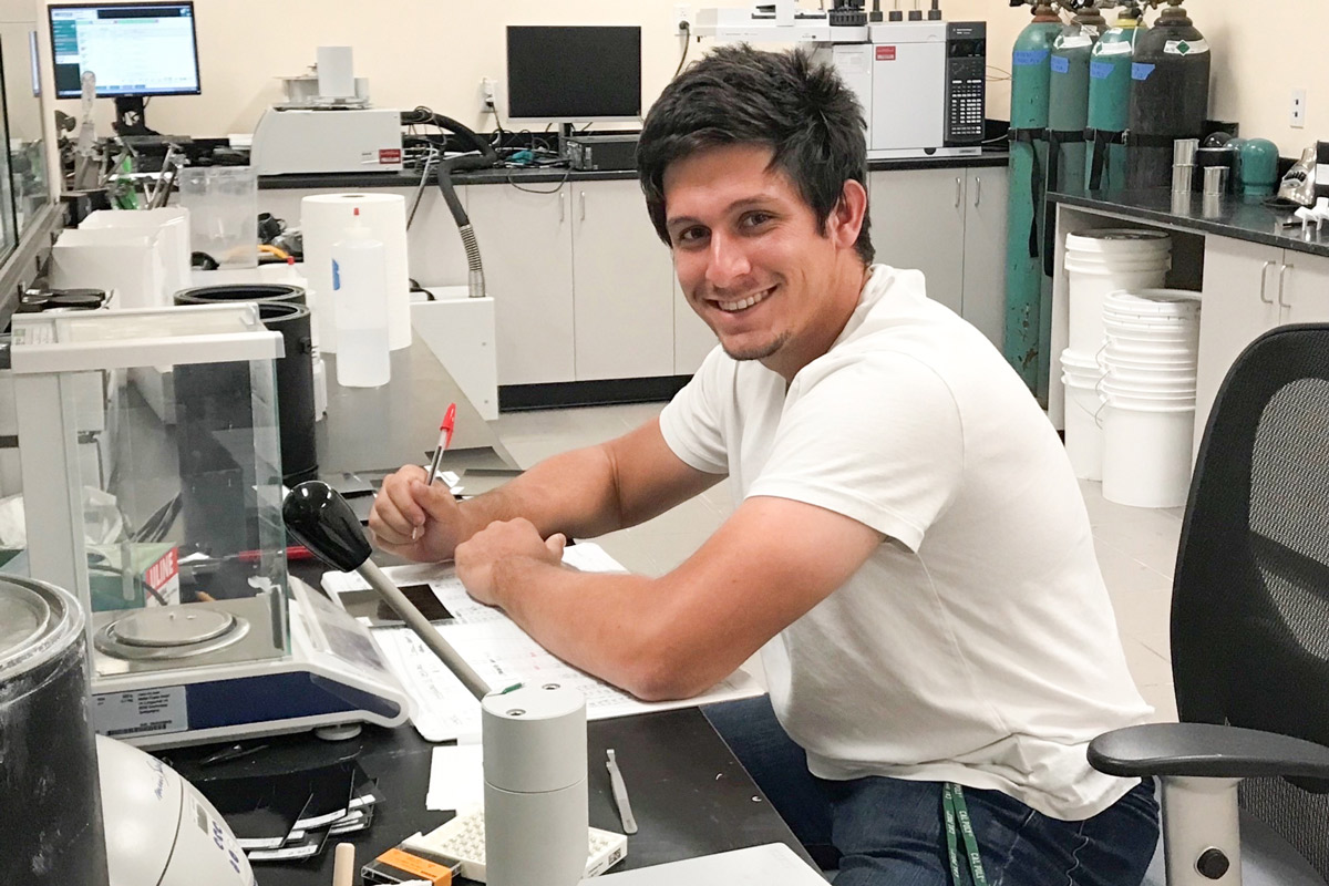 Cal Poly chemistry graduate student Adam Langevin poses in a lab