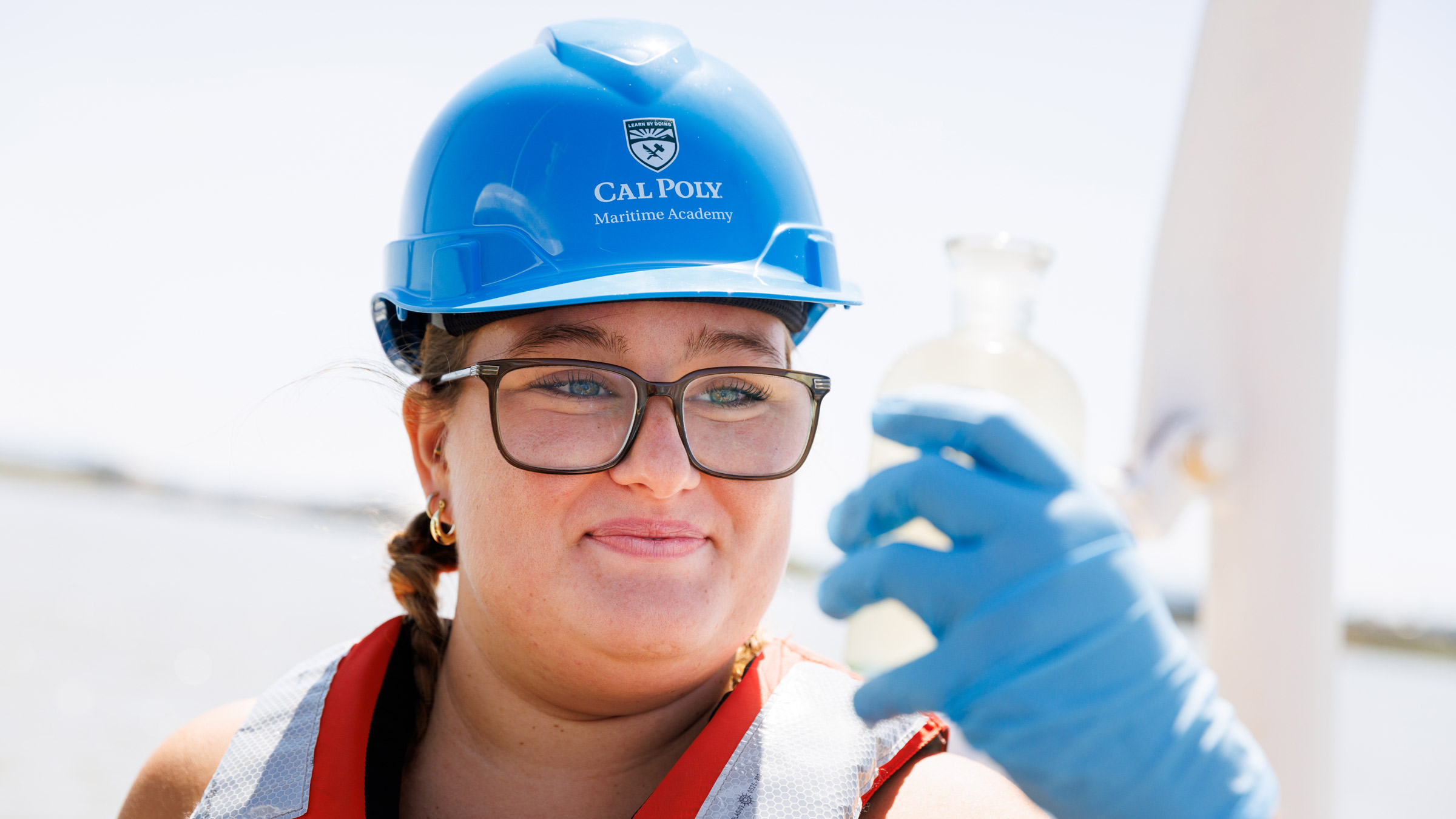 Cal Poly Maritime Academy oceanography student examines water sample