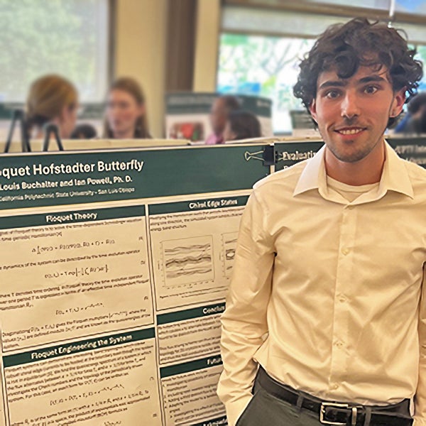 Physics student Louis Buchalter with research poster.
