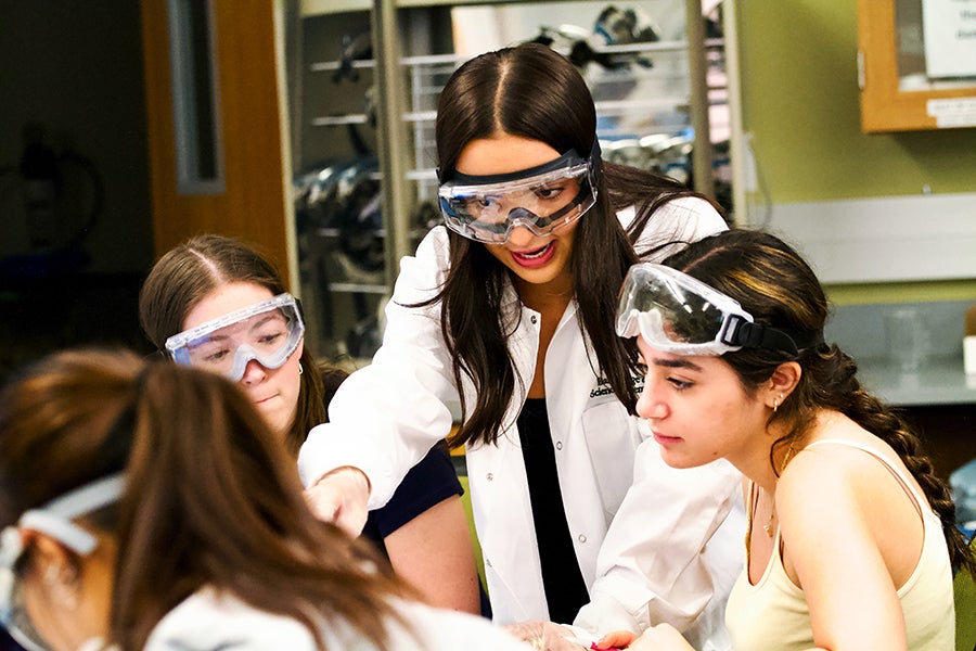 Biological sciences major Abigail Harvey, a learning assistant in chemistry and aspiring physician, helps students during a lab procedure