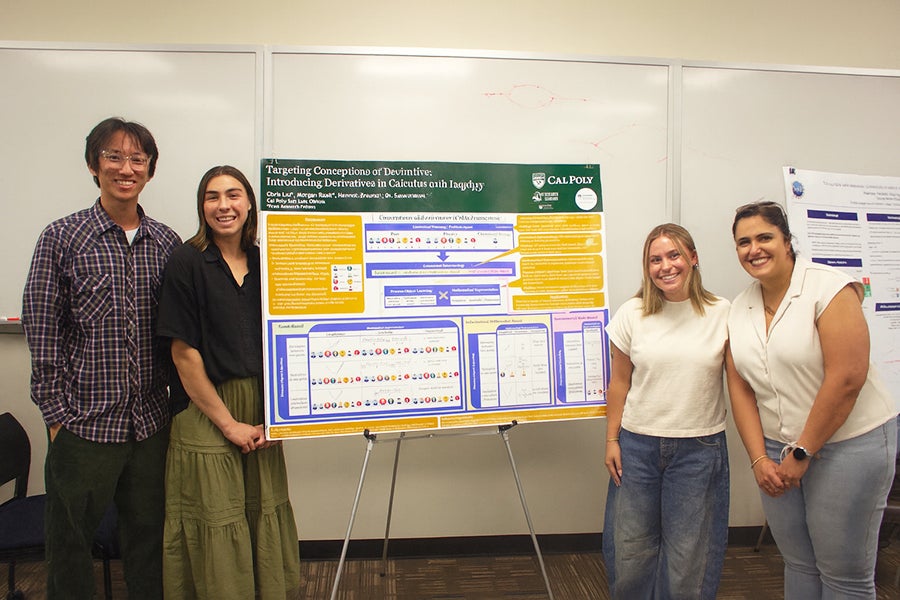 Statistics major Chris Liu, math majors Hannah Freund and Morgan Raak, and mathematics Professor Saba Gerami pose for a photo in front of a research poster