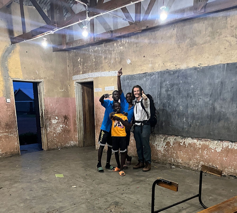 Ryan Marienthal with children in the school run by Kindle Orphan Outreach in Malawi, where they were installing lights
