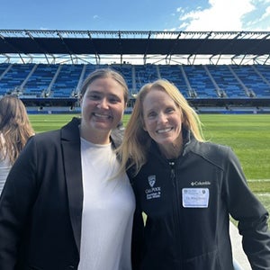 Mia Napolitano poses at the stadium with Cal Poly kinesiology and public health faculty member Nicole Hagobian.