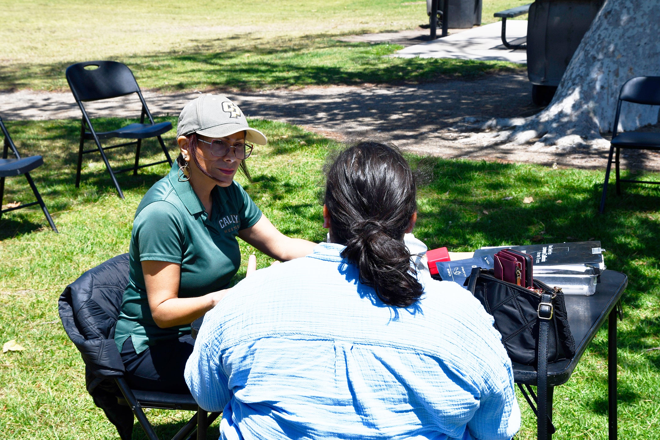 Cristina Macedo, the bilingual coordinator for Cal Poly Women's Mobile Health, meets with a patient on site before a doctor's appointment