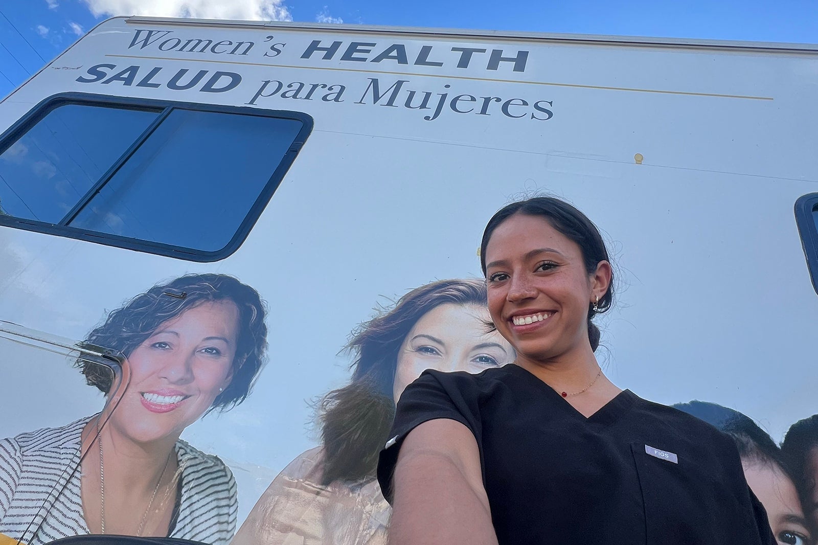 Isabel Sanchez, a Cal Poly Women's Mobile Health volunteer, poses in front of the Women's Mobile Health truck.
