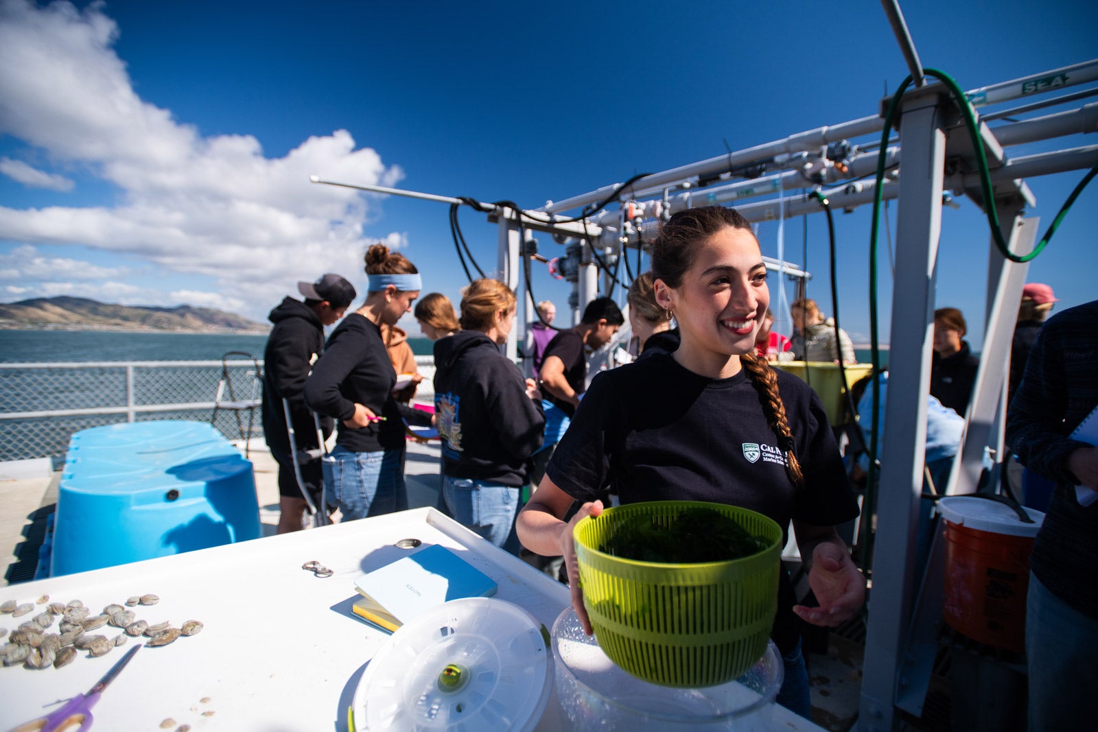 Aquaculture class students work on oyster biology using an outdoor seaweed system on the pier.