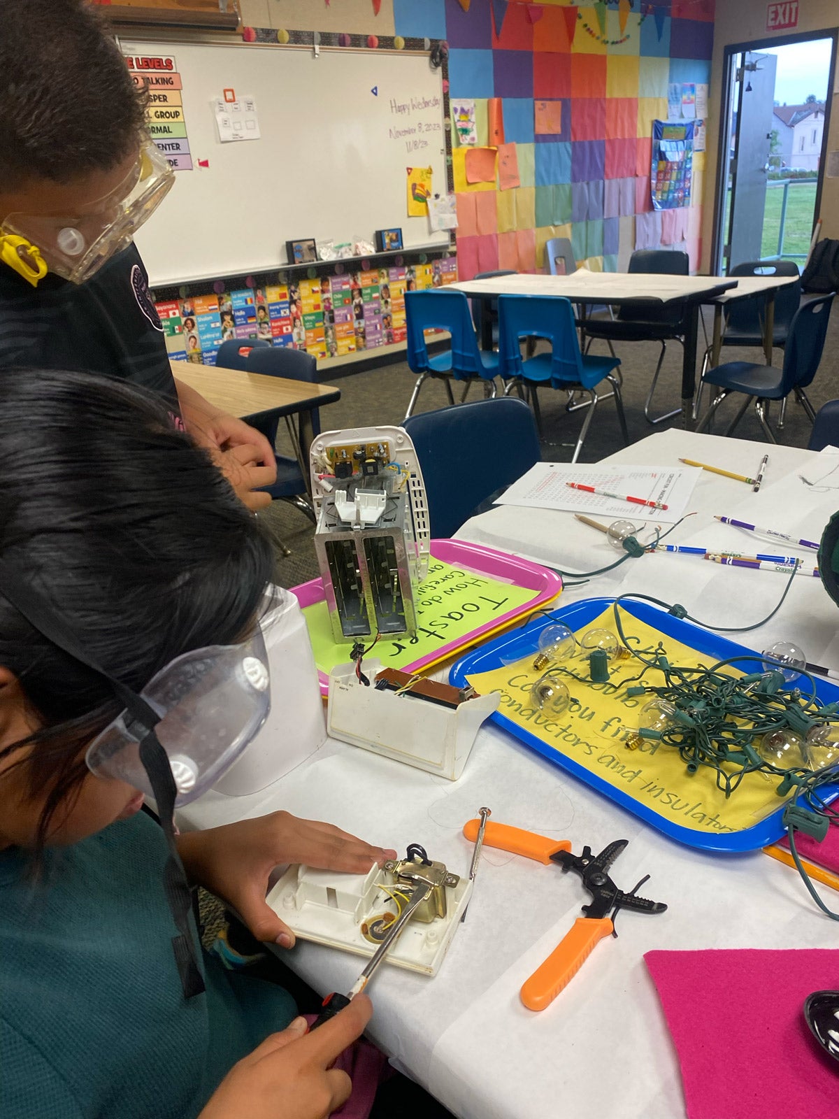 Local elementary students exploring conductors and insulators within machines.