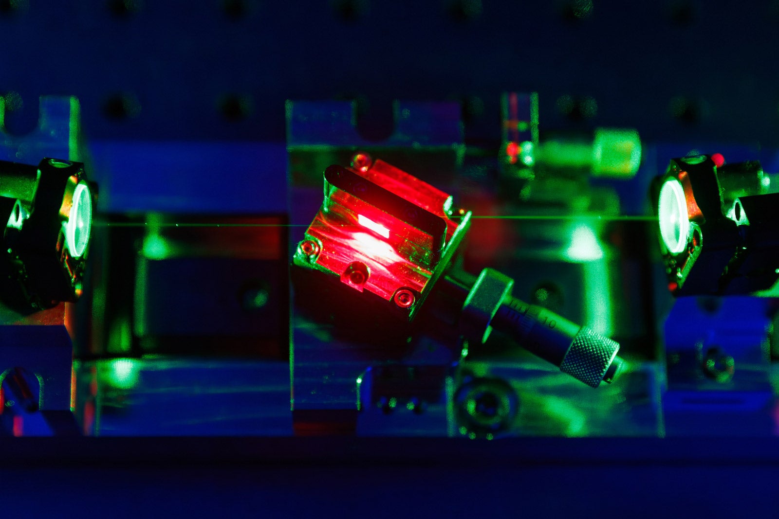 Close up of a green pump laser beam directed into a crystal within the laser