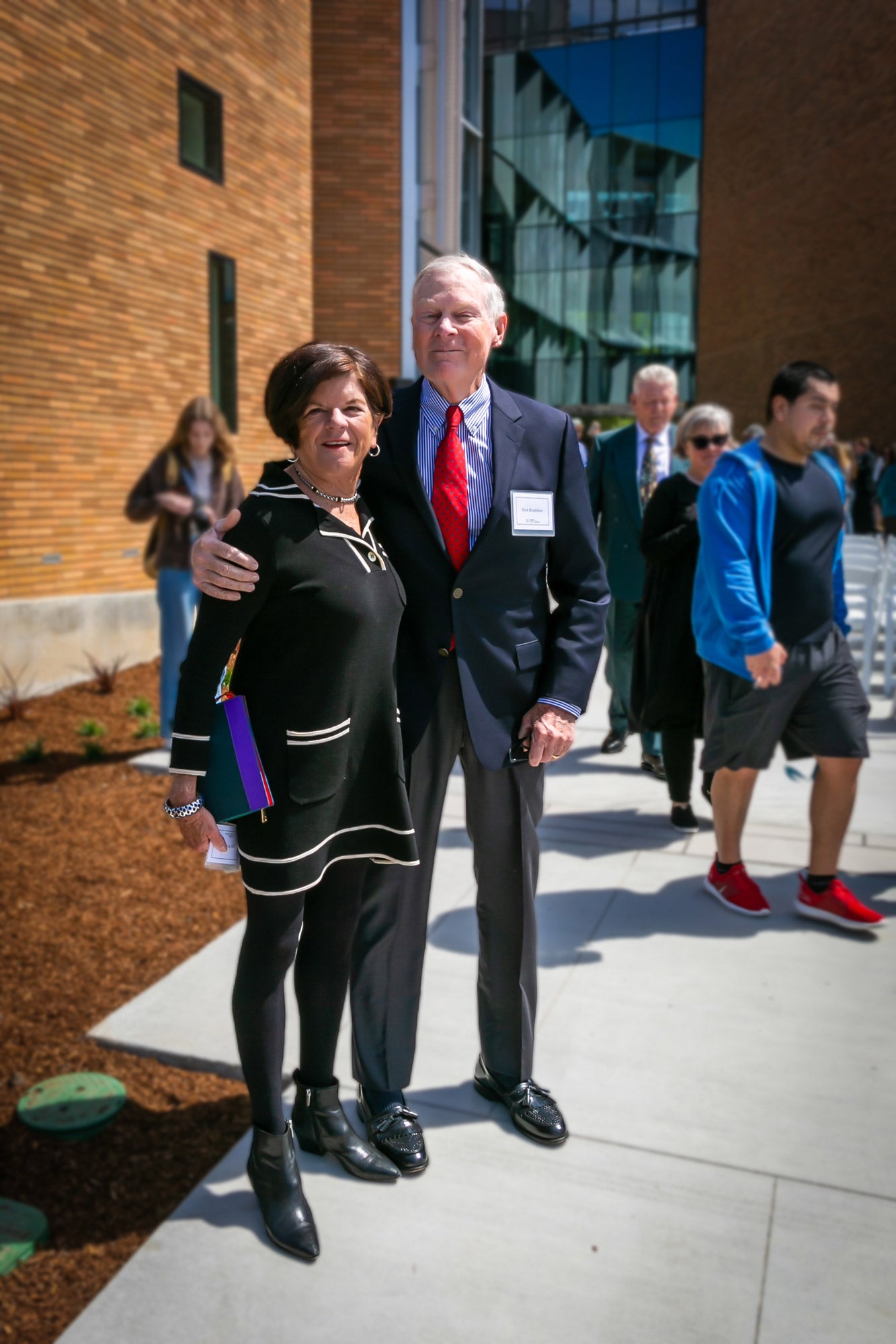 Richard and Peggy Bradshaw pose in front of the Frost Center