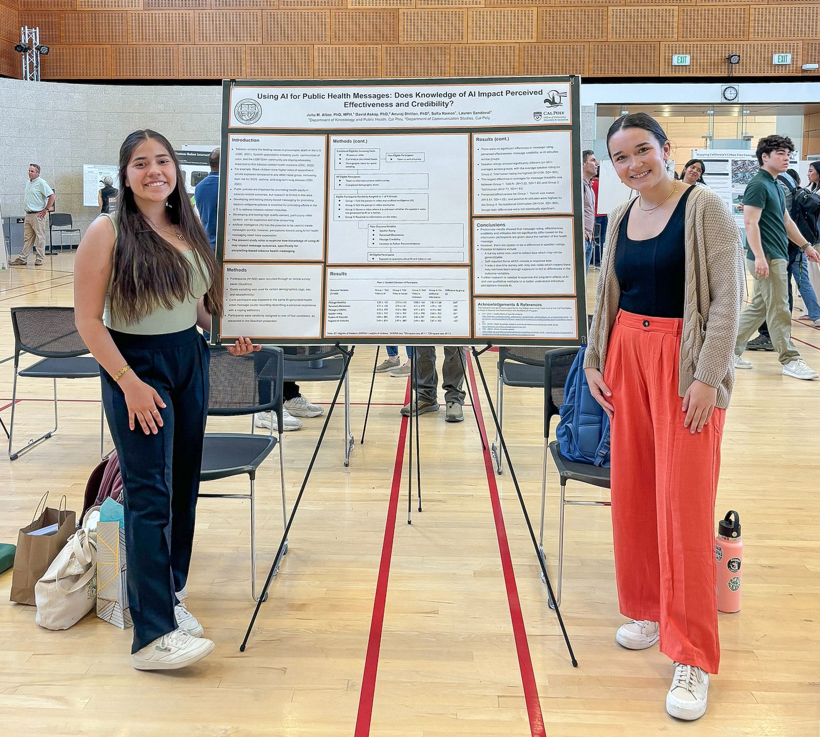 Student researchers Sofia Ramos and Lauren Sandoval present their research poster at a symposium