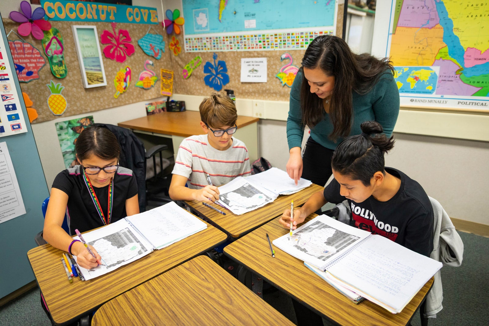 Cal Poly Student Teacher Madeine LaChapelle works with students in a 7th grade history class inside a classroom at Laguna Middle School.