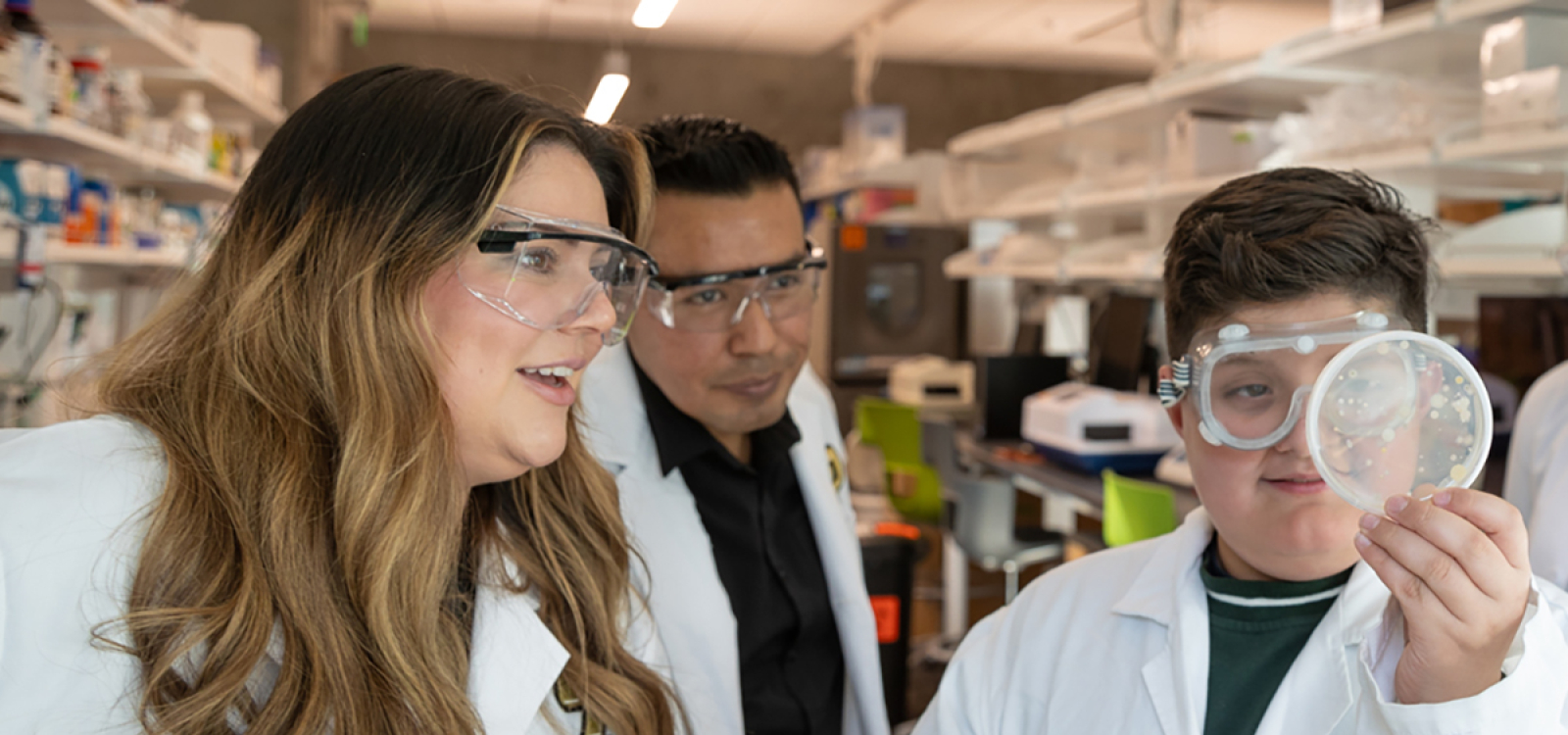 Frost Research Fellow and liberal studies student Yajaira Diaz (left) with her 10-year-old son, Isrian Lopez, and School of Education master's student José Hernandez Domitilo (center). Diaz and Domitilo were both part of the Nuestra Ciencia research group.