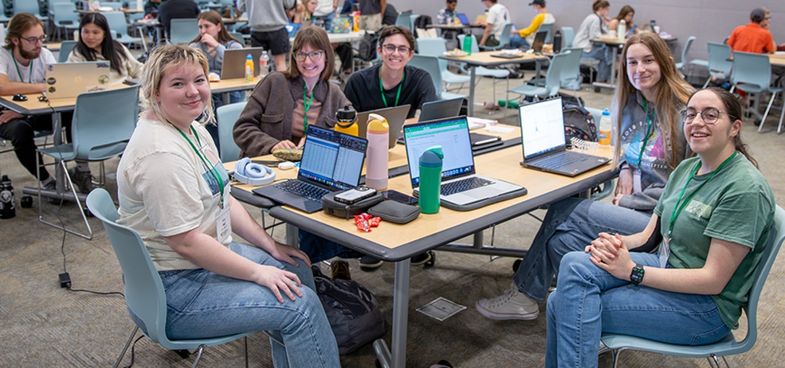 Student DataFest participants sit around tables with computers