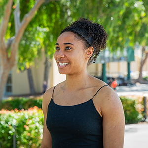 Genesis Glover, a biological sciences student at Cal Poly, smiles in a portrait taken outdoors on campus.