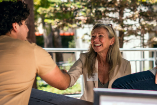 Cal Poly Alumna shaking hands with student at an outdoor mentorship event