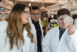 Frost Research Fellow and liberal studies student Yajaira Diaz (left) with her 10-year-old son, Isrian Lopez, and School of Education master's student José Hernandez Domitilo (center). Diaz and Domitilo were both part of the Nuestra Ciencia research group.