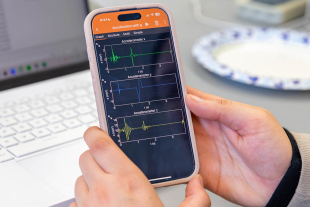 Graph of experimental data from a “Physics with Phones” activity displayed on a screen, showing plotted measurements collected from smartphone sensors during a lab experiment.
