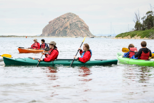 Cal Poly students and members of the Adapted Paddling Program and their clients paddle kayaks in Morro Bay.