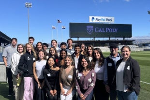 Kinesiology students pose at the San Jose Earthquakes stadium amid a day meeting with industry professionals, including Cal Poly alumni. 