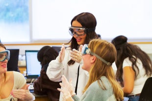 Biological sciences major Abigail Harvey, a learning assistant in chemistry and aspiring physician, helps students during a lab procedure
