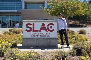 Physics major Cameron Corley poses in front of SLAC Science and User Support Building