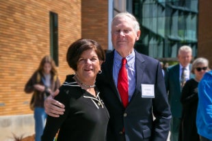 Richard and Peggy Bradshaw pose in front of the Frost Center