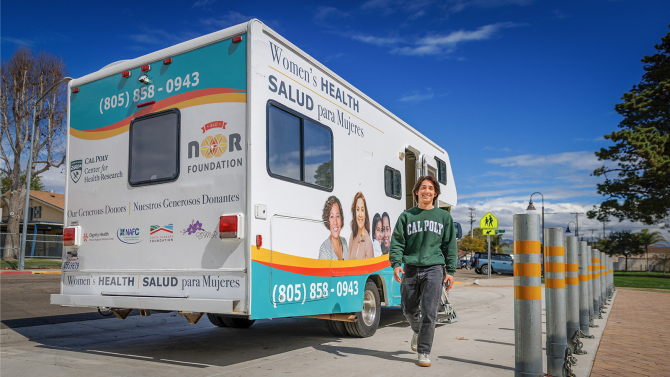 A public health student volunteers with Cal Poly's Mobile Health Unit, providing free care to vulnerable local populations.