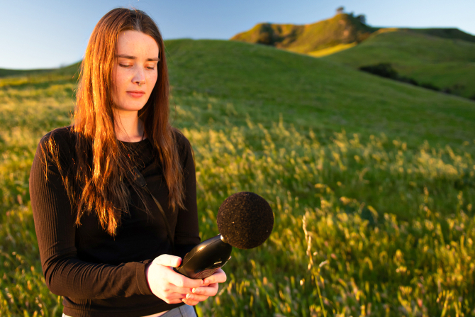 Biological sciences graduate student Eva Moylan uses a passive acoustic monitor as part of her studies on the impacts of noise and light pollution on bird behavior and population declines.