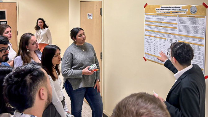 School of Education graduate student presenting research at a symposium