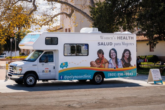 Cal Poly Women's Mobile Health truck parked next to a building