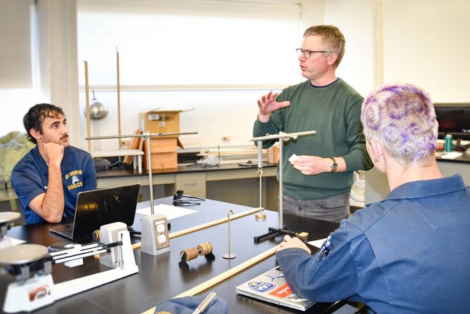 Two Oceanography students sit in a lab listening to a professor