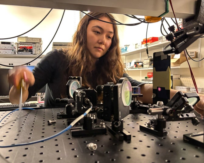 Frost Scholar Hannah Reilly (’26) constructing the optical setup for the magneto-optical trap to laser cool atoms.